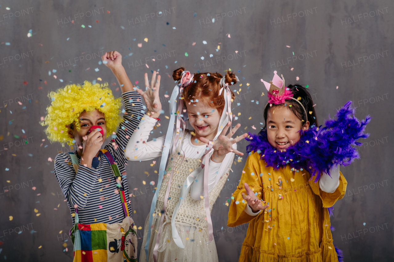 Portrait of three children in funny costumes.