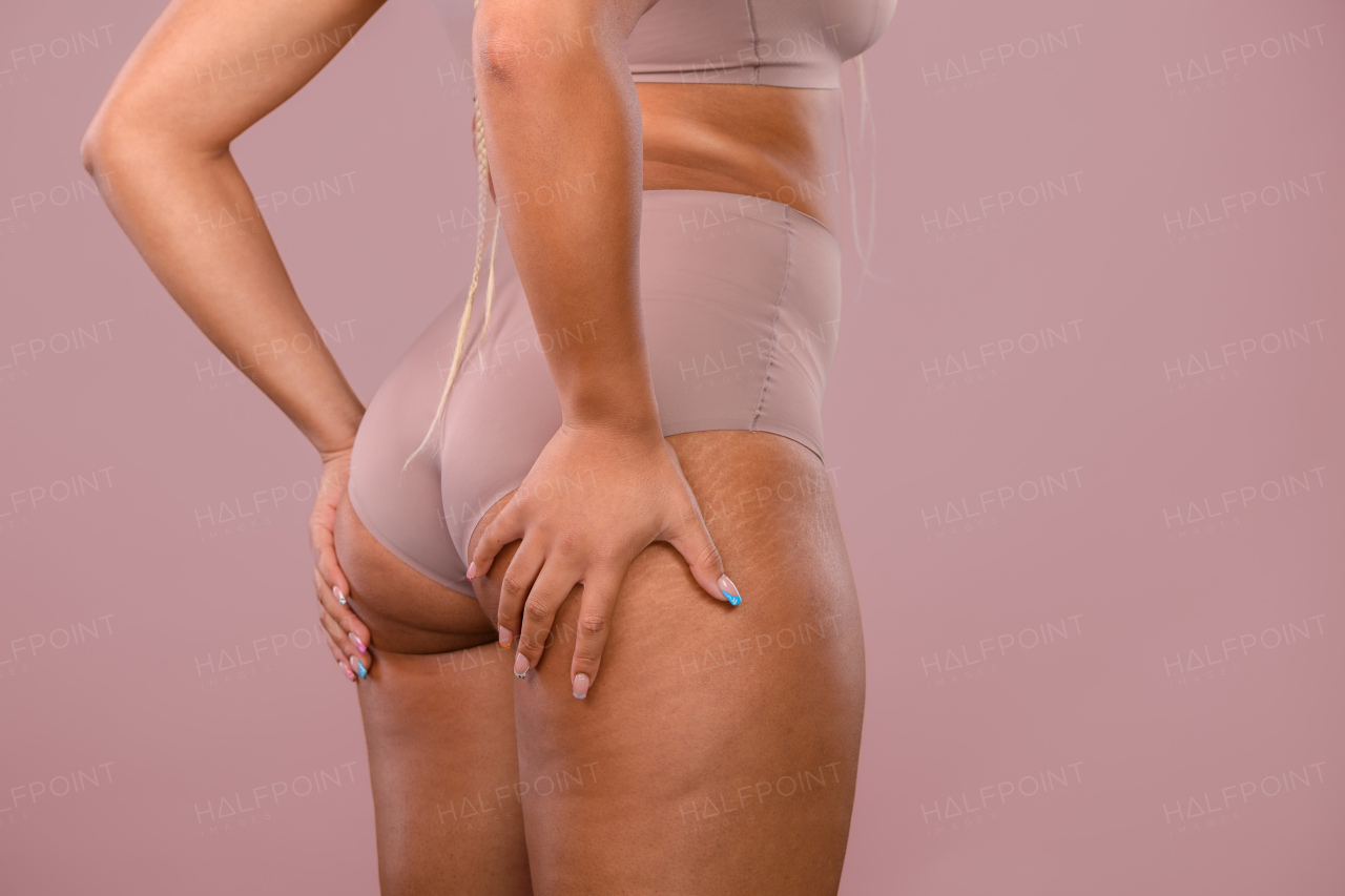 Close-up of a young womans body, studio shoot.