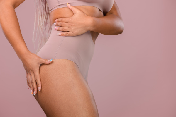 Close-up of a young womans body, studio shoot.