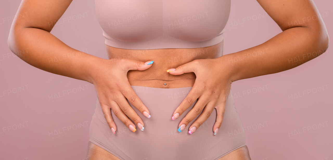 Close-up of a young womans body, studio shoot.