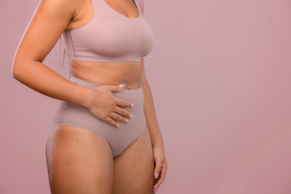 Close-up of a young womans body, studio shoot.