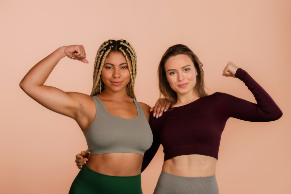 Studio portrait of young friends in sportive clothes.