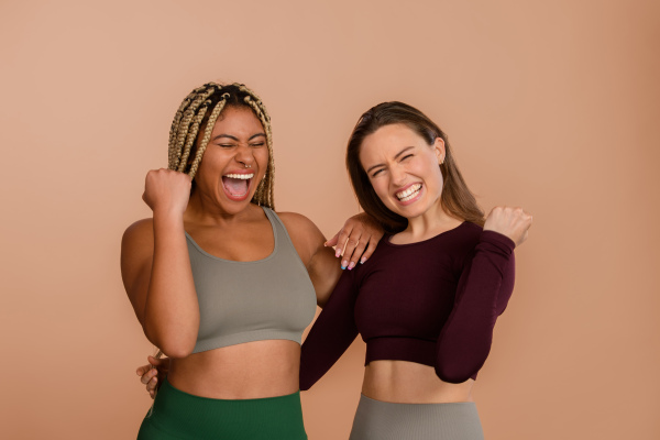 Studio portrait of young friends in sportive clothes.