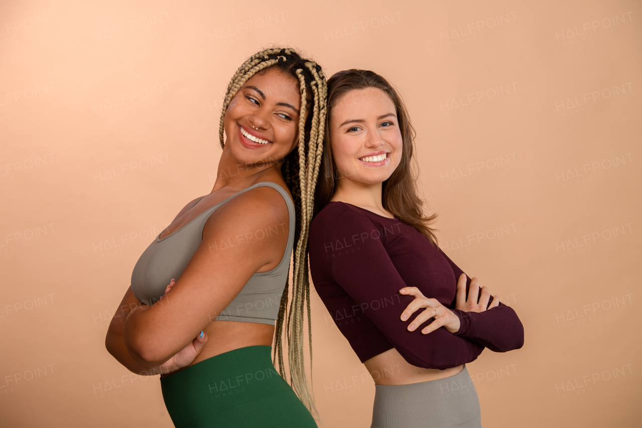 Studio portrait of young friends in sportive clothes.