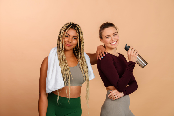 Studio portrait of young friends in sportive clothes.