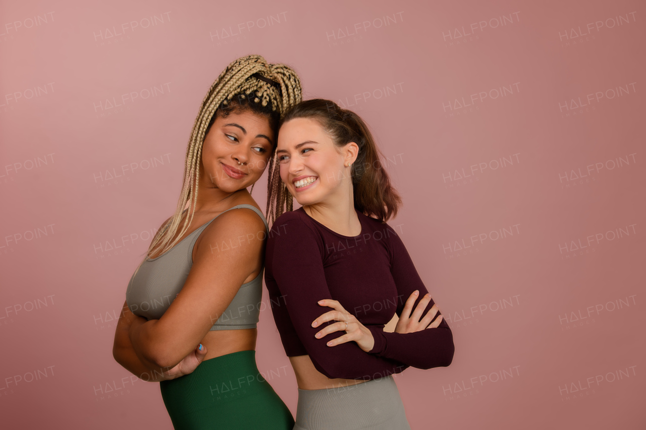 Studio portrait of young friends in sportive clothes.