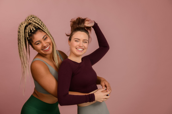 Studio portrait of young friends in sportive clothes.