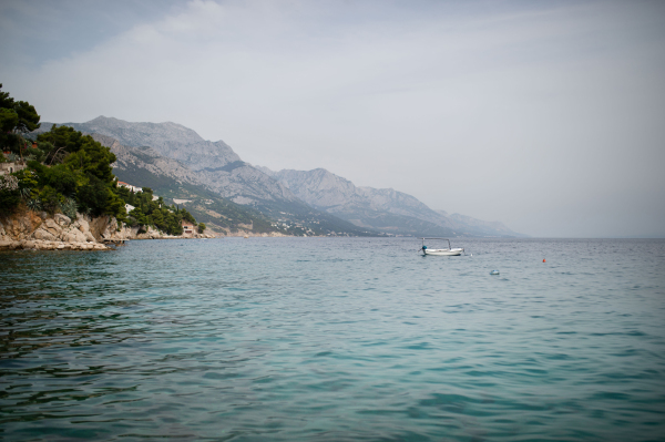 A landscape of town in the Adriatic sea coast under mountain in Croatia, during summer sunny day