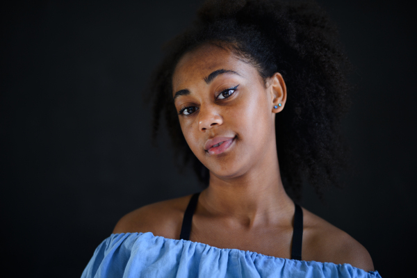 A beautiful teenage Afro American girl looking at camera and smiling