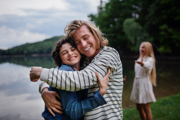 Friends having fun together at a park lauging and hugging, Friendship and lifestyle concepts