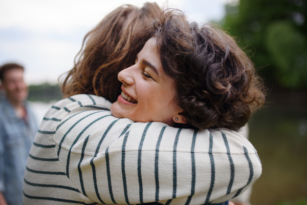 Friends having fun together at a park lauging and hugging, Friendship and lifestyle concepts