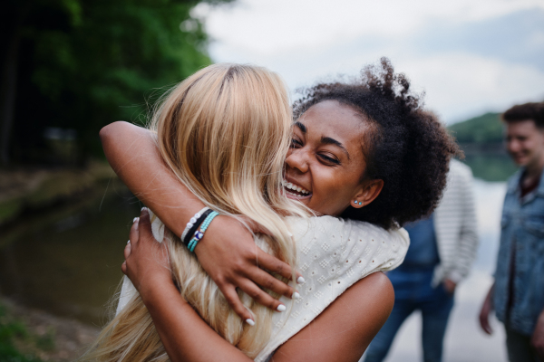 Friends having fun together at a park lauging and hugging, Friendship and lifestyle concepts