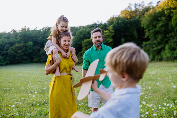 A happy young family spending time together outside in green nature.