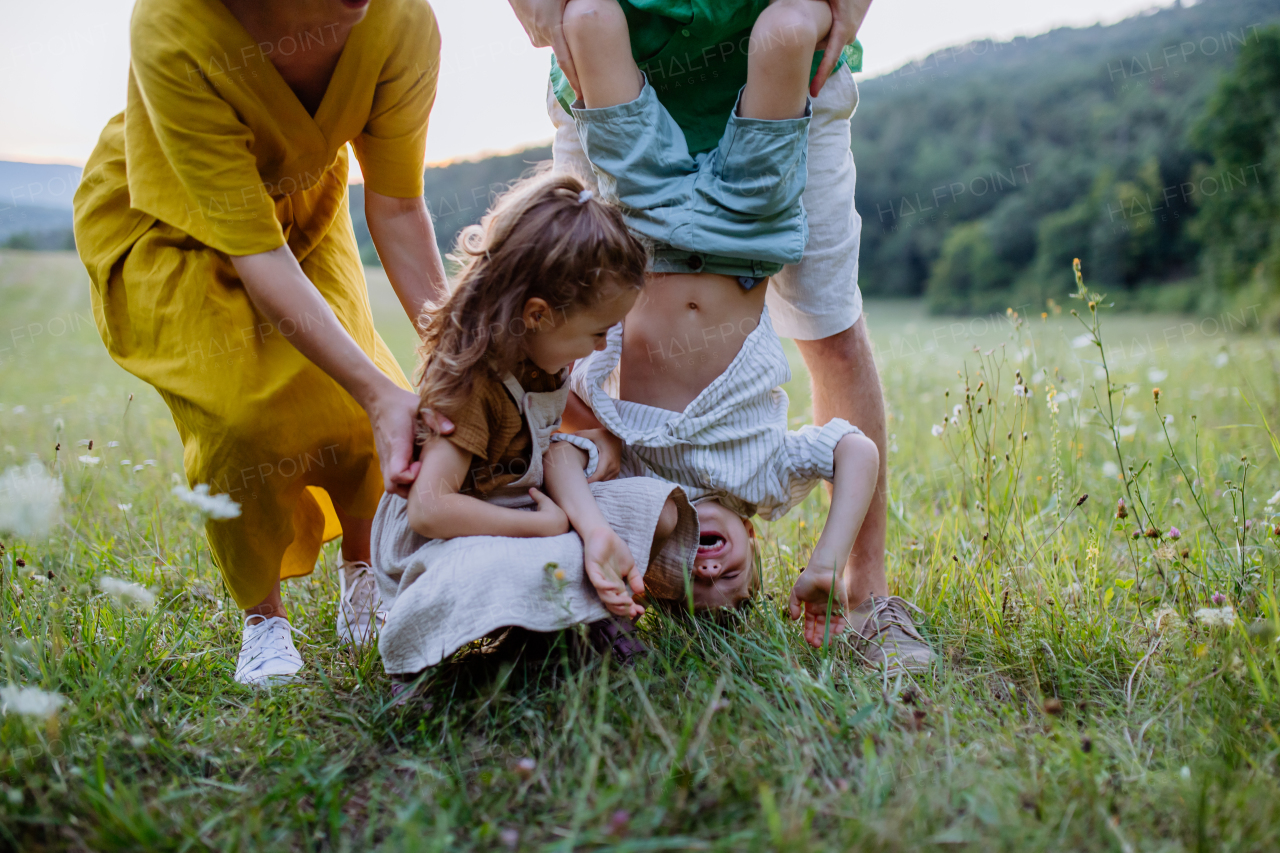 A happy young family having fun together outside in green nature.