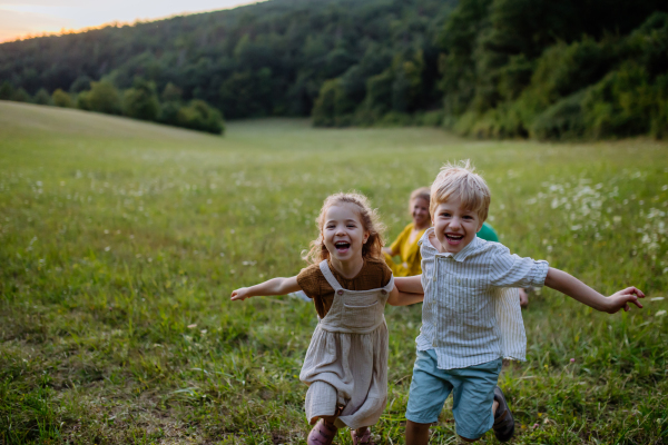 A happy young family spending time together outside in green nature.