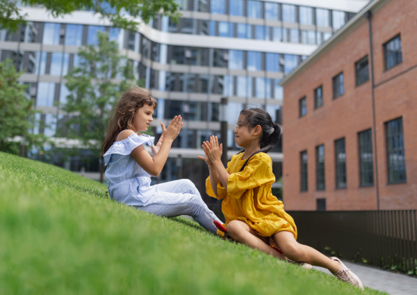 LIttle girls playing outdoor in the city park.