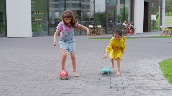 Happy children enjoying a skateboard ride.