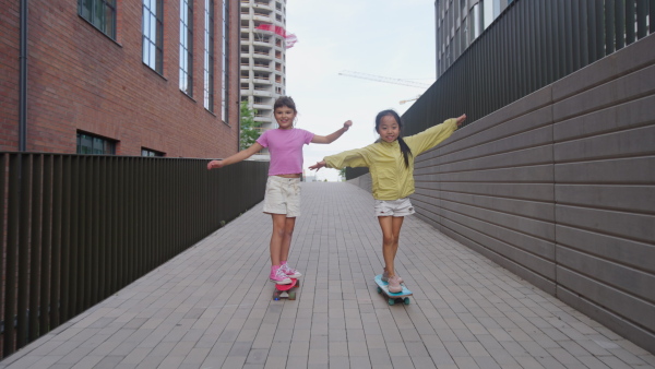 Happy children enjoying a skateboard ride.