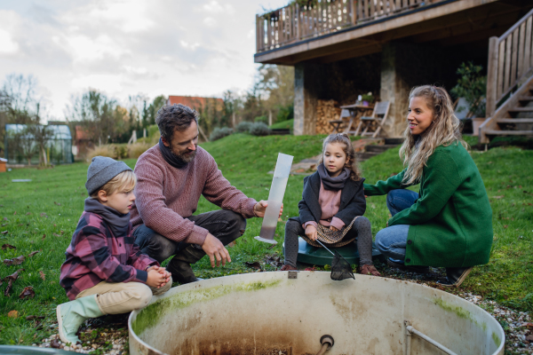 The family checking the water quality in the home wastewater or sewage treatment system. Concept of sustainable family living.