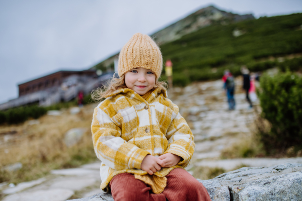 Portrait of little girl during autumn hike in the mountains.