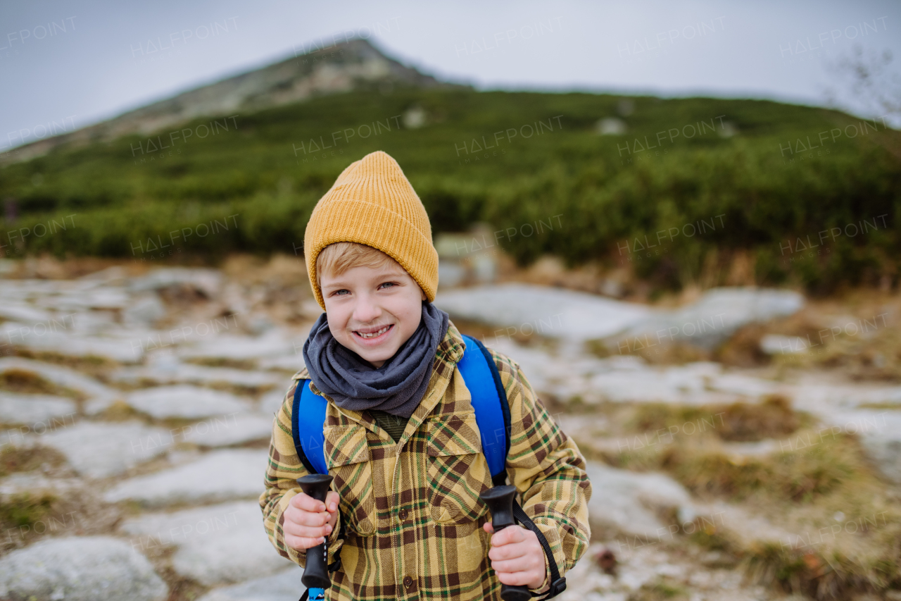 Portrait of little boy hiking in the mountains.