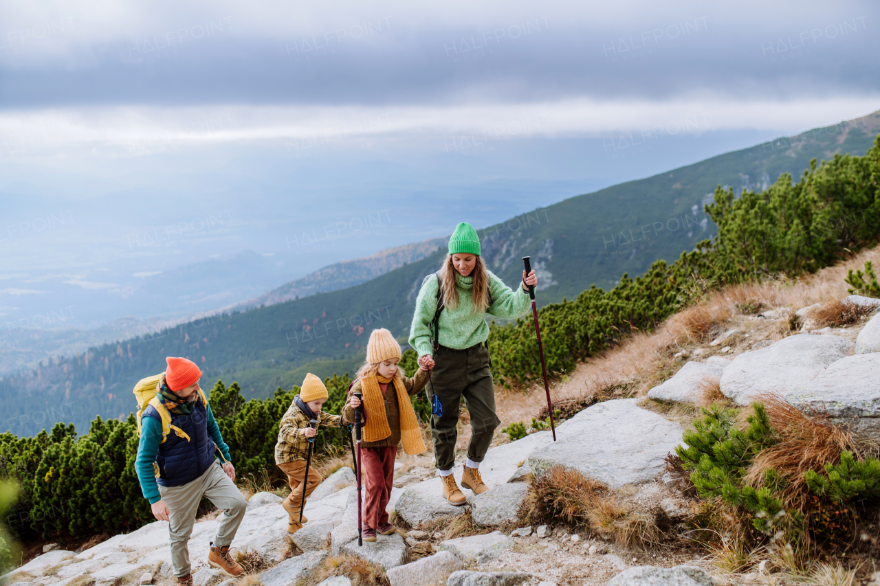 Happy family hiking together in an autumn mountains.