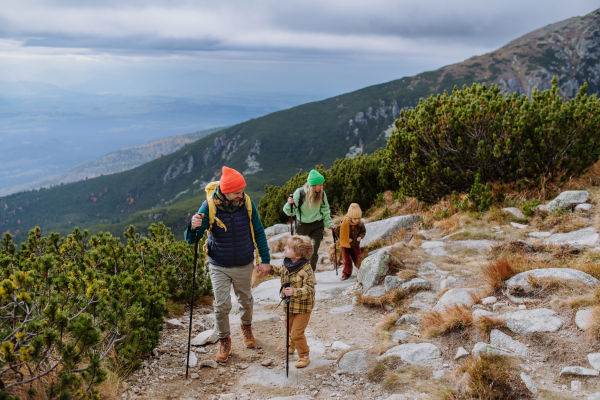 Happy family hiking together in an autumn mountains.