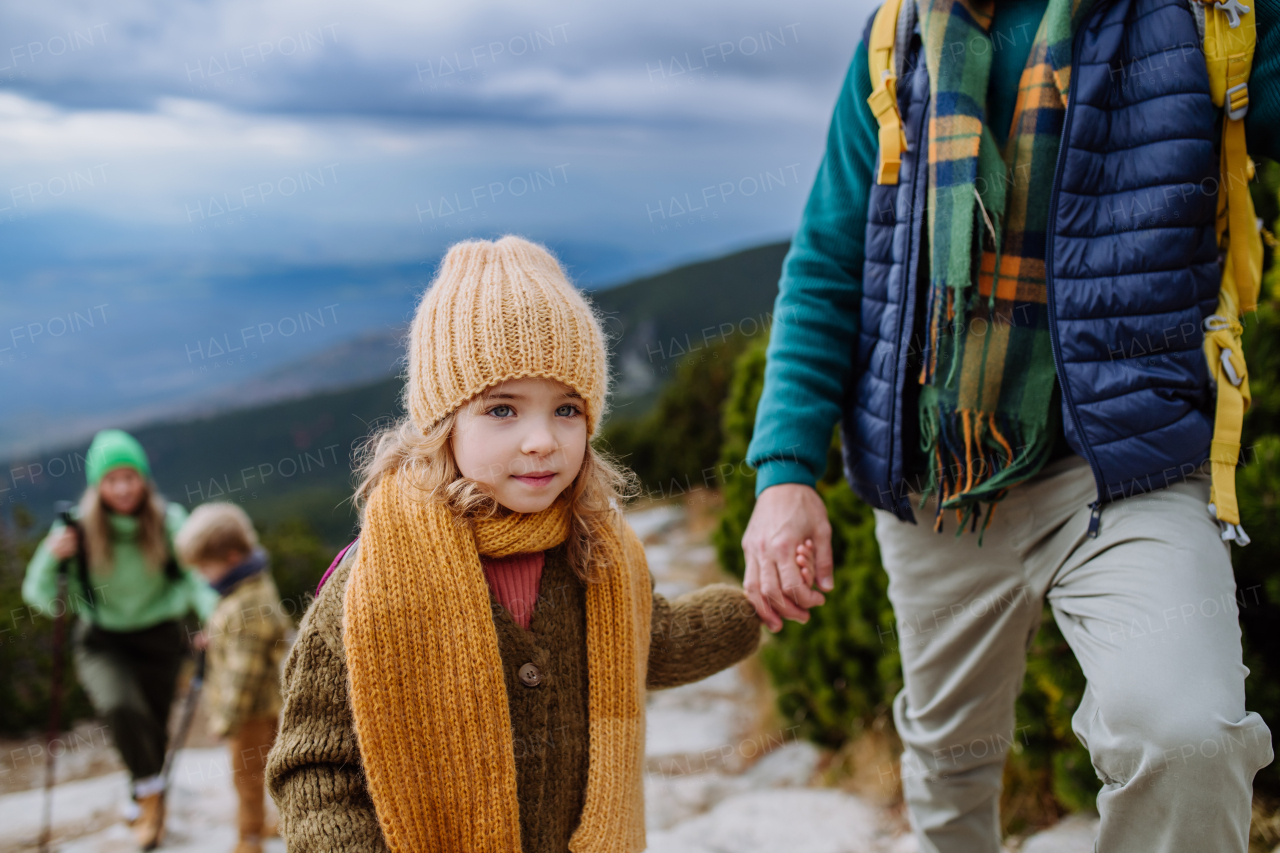 Happy family hiking together in an autumn mountains.