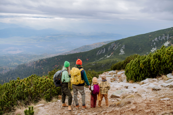 Happy family hiking together in an autumn mountains.