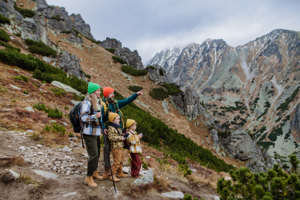 Happy family hiking together in an autumn mountains.