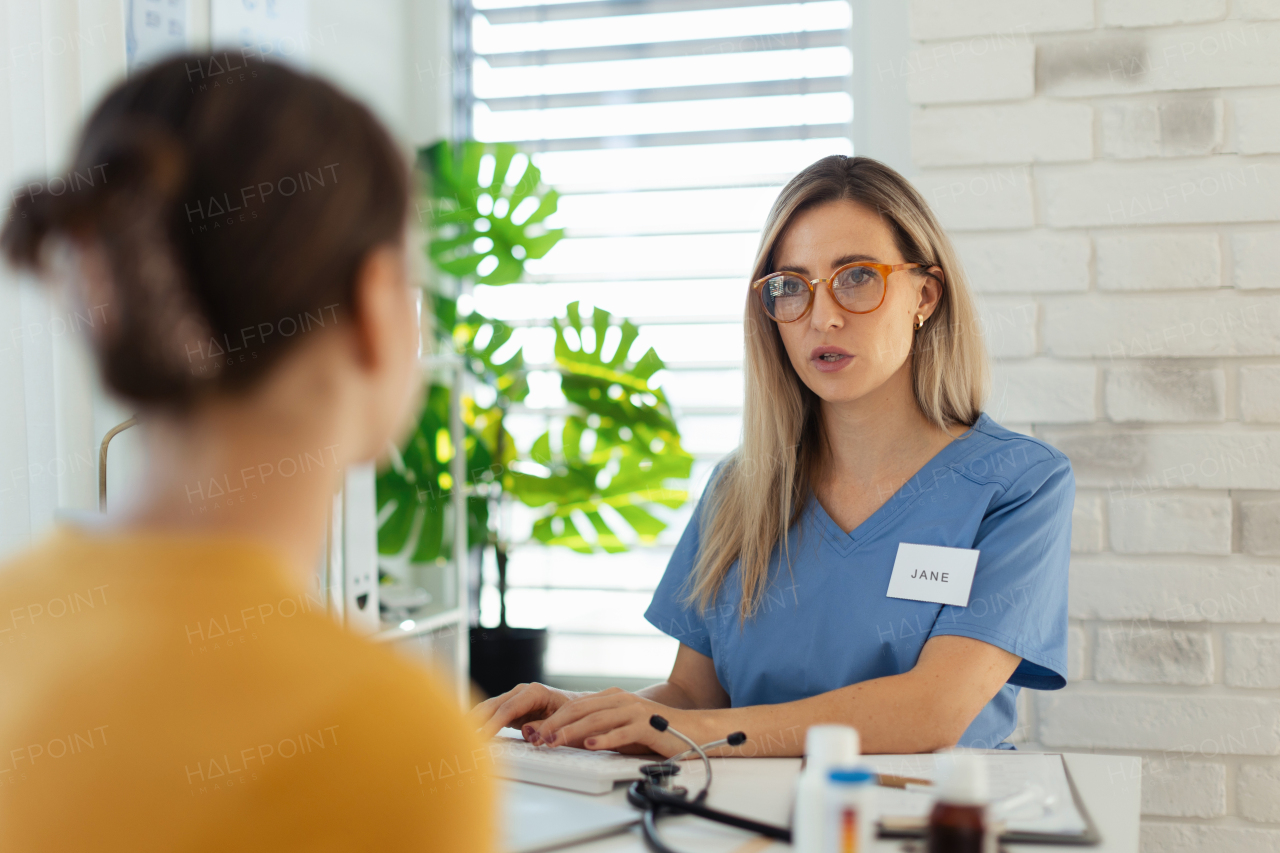 Teenage girl discussing test results with paediatrician. Doctor prescribing medication to ill teenage girl. Concept of preventive health care for adolescents.