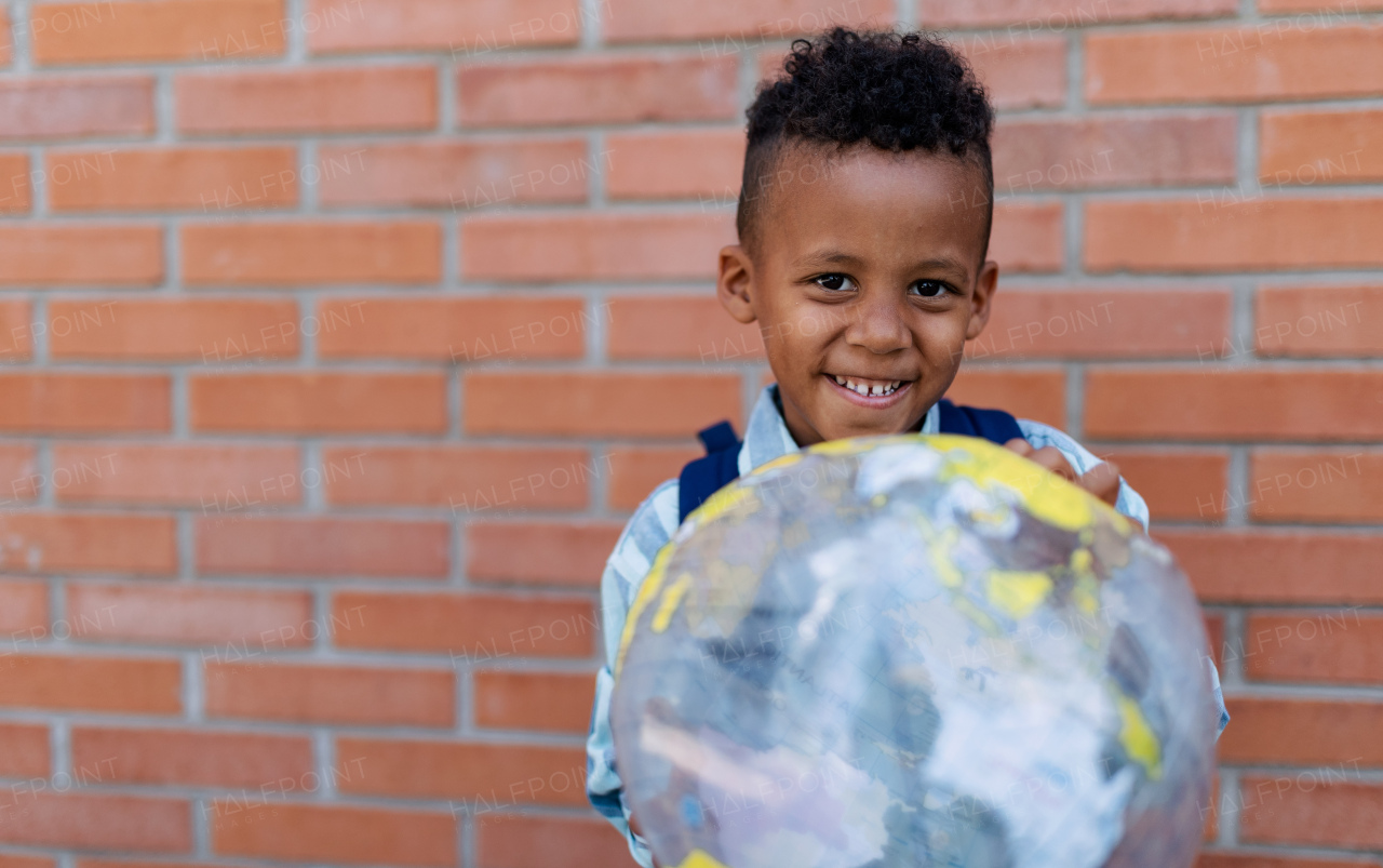 Multiracial boy playing outdoor with a beach ball.