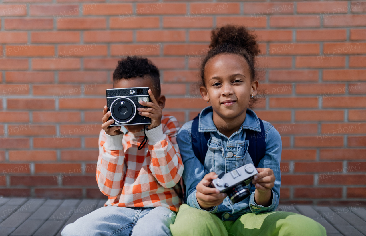 Multiracial siblings taking photos outdoor, enjoying holiday.