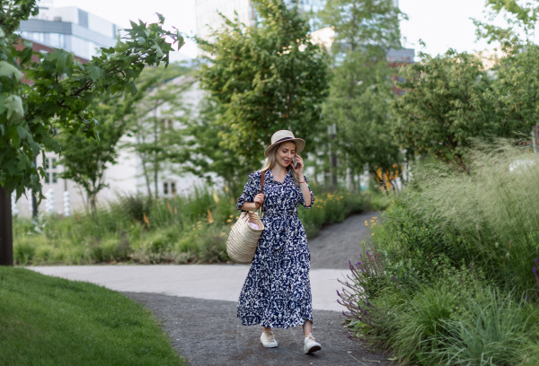 Mature woman walking in a park, enjoying time for herself.