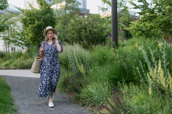 Mature woman walking in a park, enjoying time for herself.