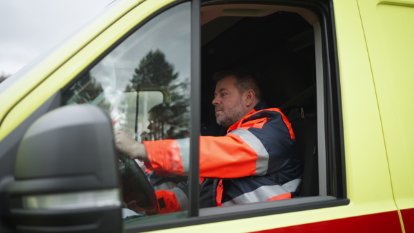 Video of man doctor sitting in the ambulance car.