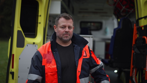 Video of a man doctor standing in front of ambulance car.