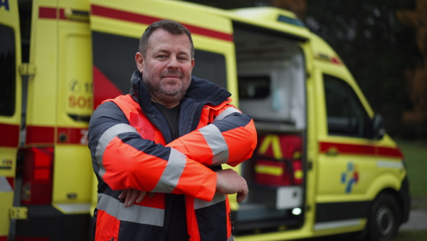 Video of a man doctor standing in front of ambulance car.