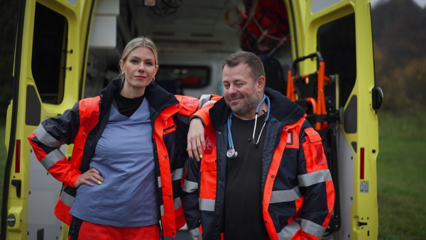 Video of rescuers, colleagues in front of ambulance car.