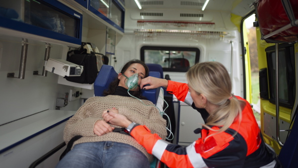 Rescuer taking care of a patient, preparing her for transport.