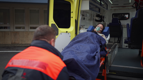 Video of rescuer getting empty stretcher inside ambulance vehicle.