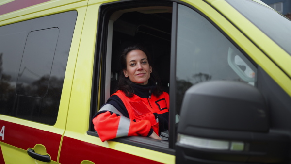 Video of young woman doctor sitting in the ambulance car.