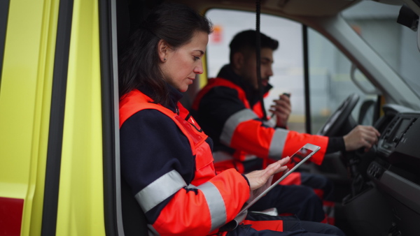 Team of rescuers preparing in an ambulance car to outdoor operation.