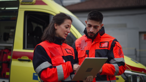 Team of rescuers preparing in an ambulance car to outdoor operation.