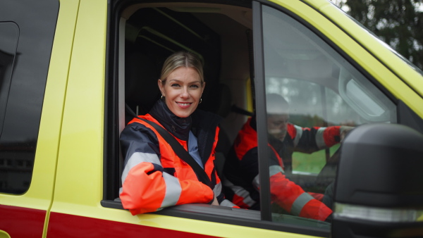 Video of young woman doctor sitting in the ambulance car.