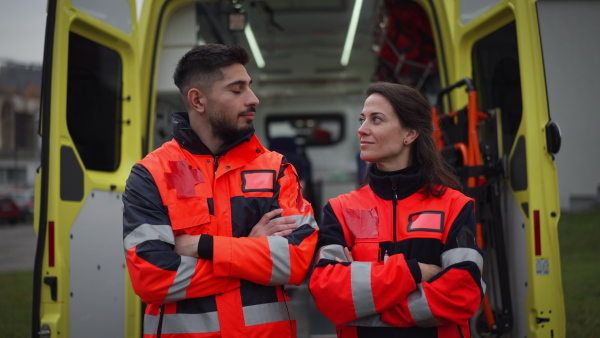 Video of rescuers, colleagues in front of ambulance car.