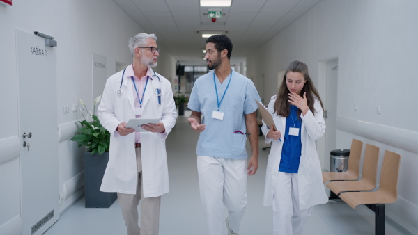 Team of doctors talking at a hospital corridor.