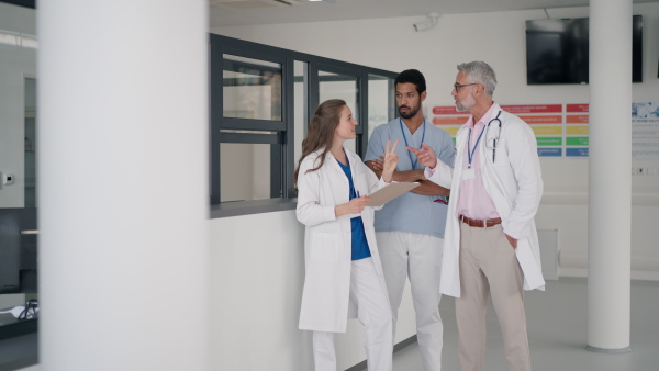 Doctors discussing something at a hospital corridor.