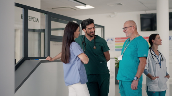 Medical staff discussing something at a hospital corridor.