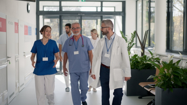 Group of doctors at hospital corridor, going for daily chceck up of patients.